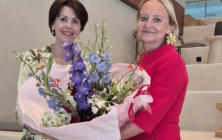 NBCC CEO Lyne Biewinga overhandigt bloemen and Janet Poot